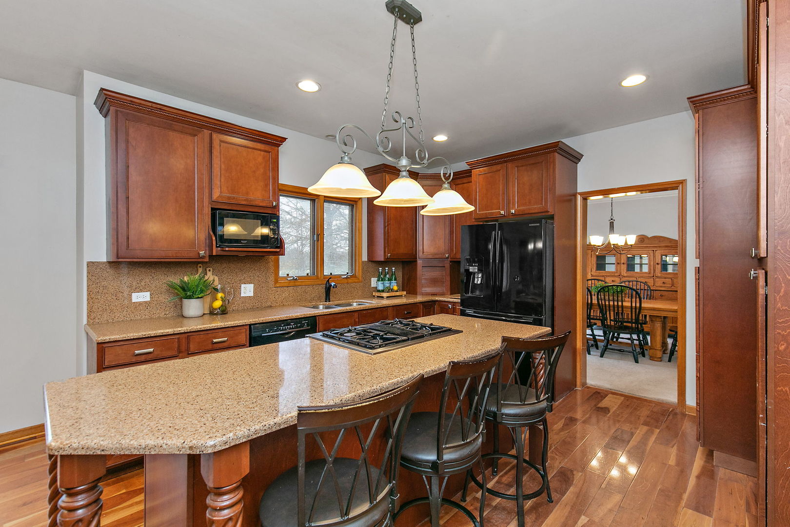 39W462 Baert Road St. Charles, IL 60175 - Photo 4 of 41 a kitchen with granite countertop a stove a sink a dining table and chairs