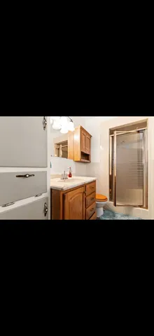 a kitchen with a sink a stove and white wall