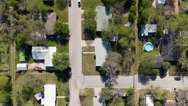 an aerial view of a house with a yard