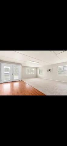 a view of room with wooden floor