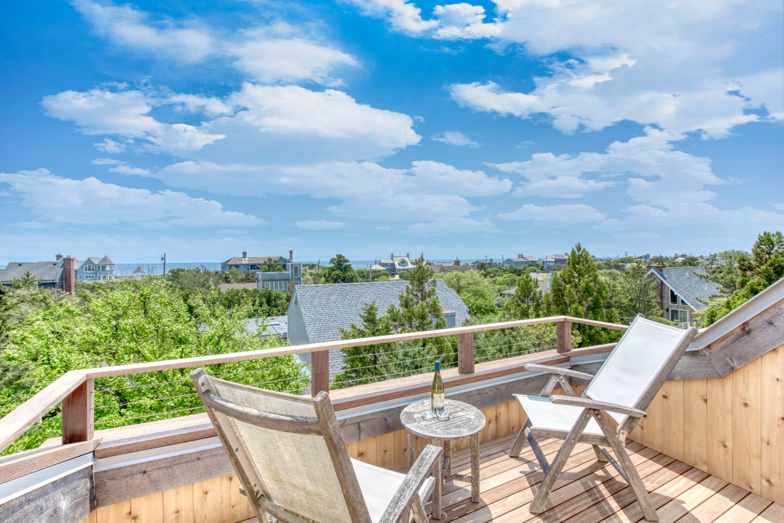 a view of a balcony with mountain view and wooden floor