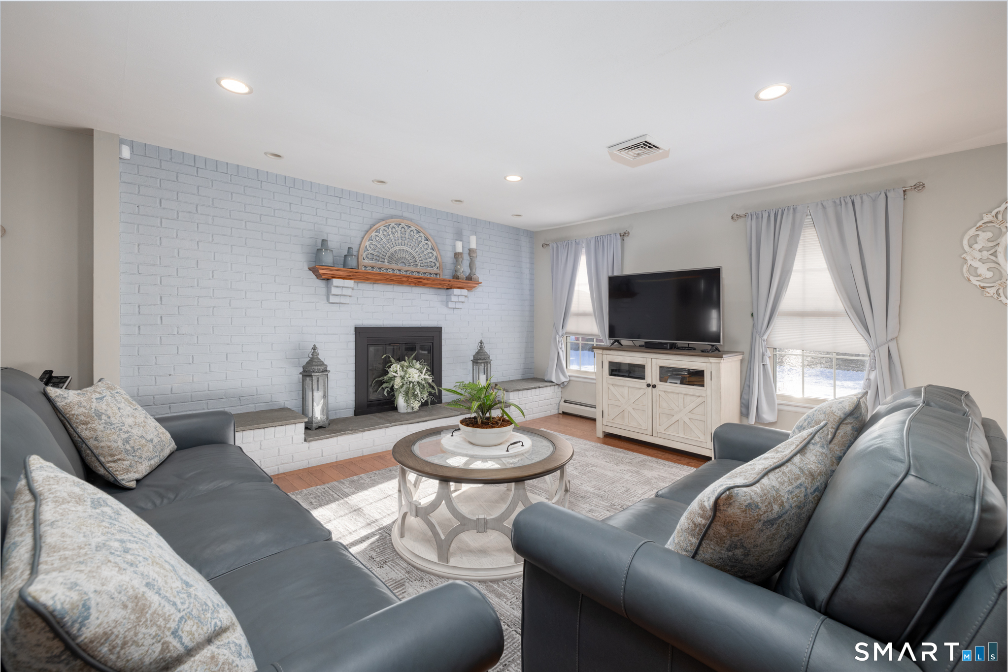 40 November Lane Southington, CT 06479 - Photo 5 of 33 a living room with furniture a flat screen tv and a fireplace