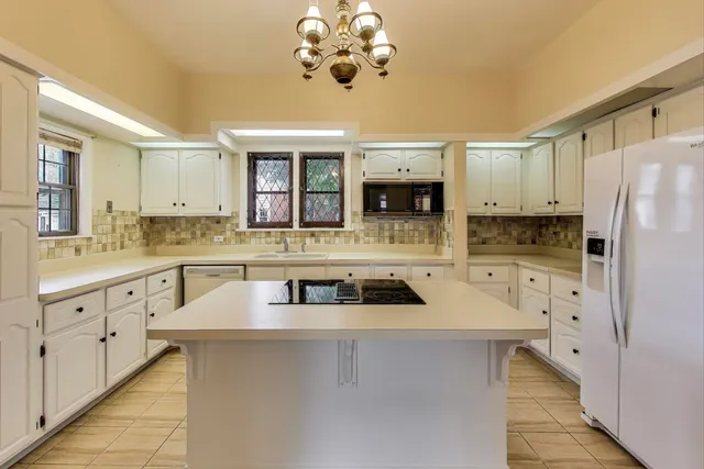 a view of an empty room with wooden floor and windows