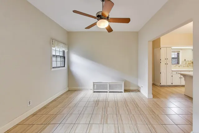 a view of a room with wooden floor and window