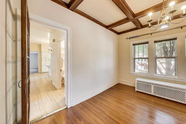 a view of a room with wooden floor and windows