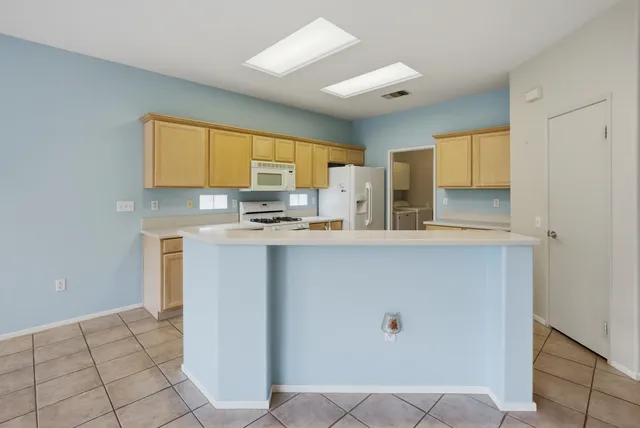 a large kitchen with stainless steel appliances cabinets and a sink