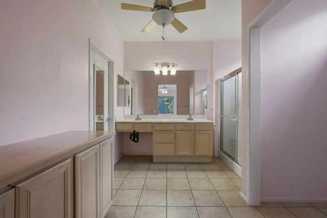 a bathroom with a sink vanity granite shower and a mirror