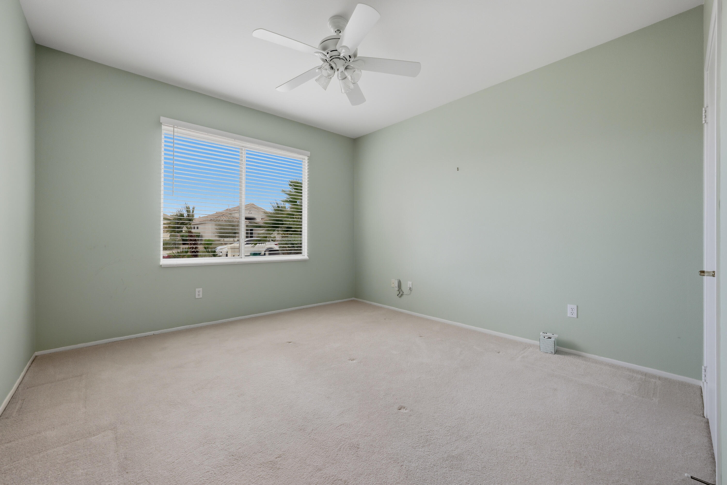 37410 Medjool Avenue Palm Desert, CA 92211 - Photo 27 of 32 an empty room with windows and ceiling fan