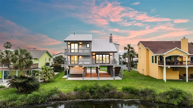 an aerial view of a house with a yard table and chairs