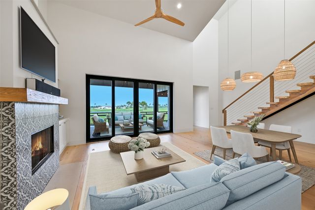 a large kitchen with stainless steel appliances kitchen island granite countertop a large counter top and a stove top oven