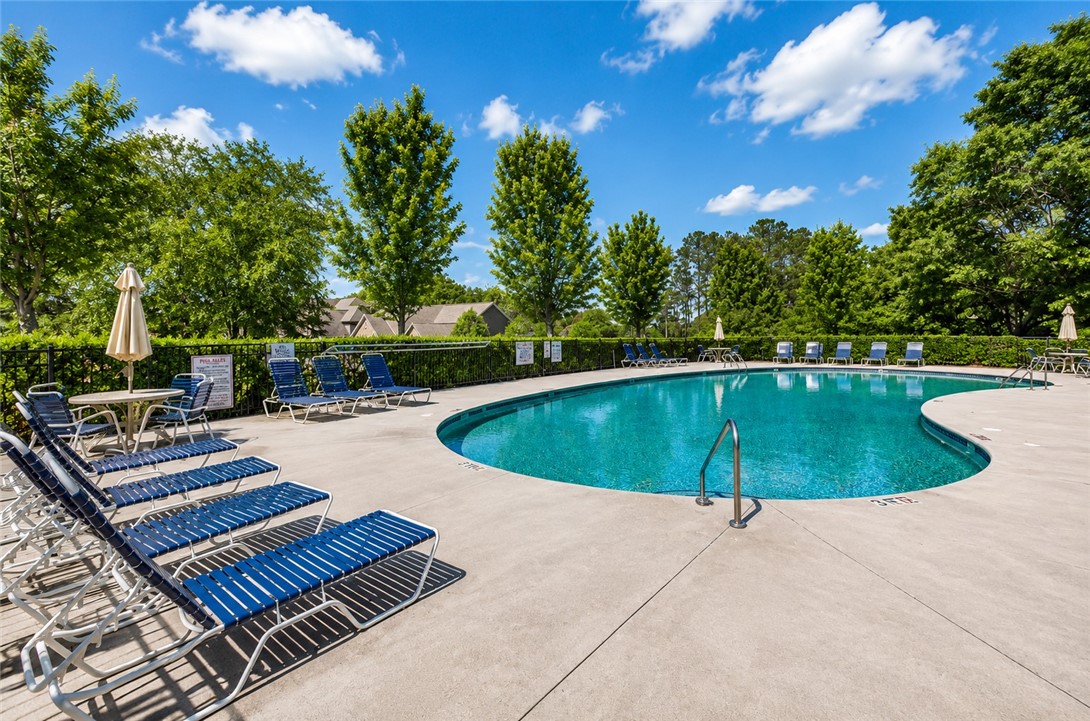 15 Fawn Hill Drive Anderson, SC 29621 - Photo 34 of 38 Relax poolside with ample space for lounging and recreation, all set against a lush, green backdrop.
