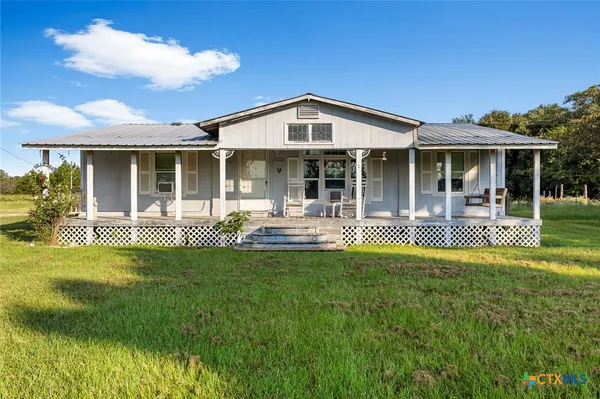 a view of a house with pool and garden