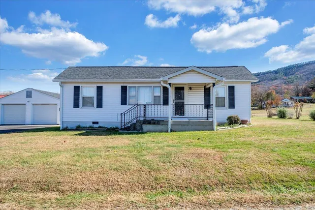 a backyard of a house with table and chairs