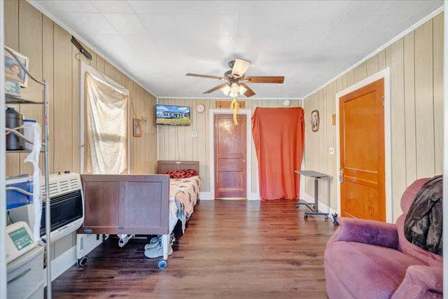 a bed sitting in a bedroom next to a window
