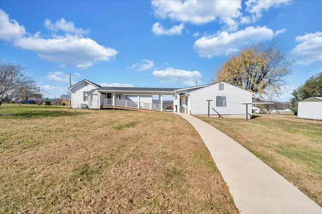 a view of a yard with a house in the background