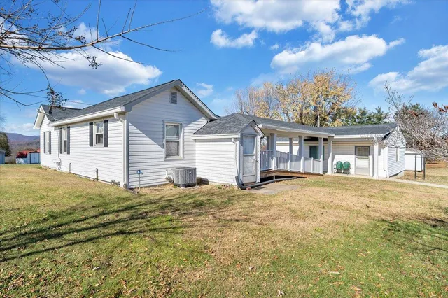 a house view with swimming pool and trees in the background