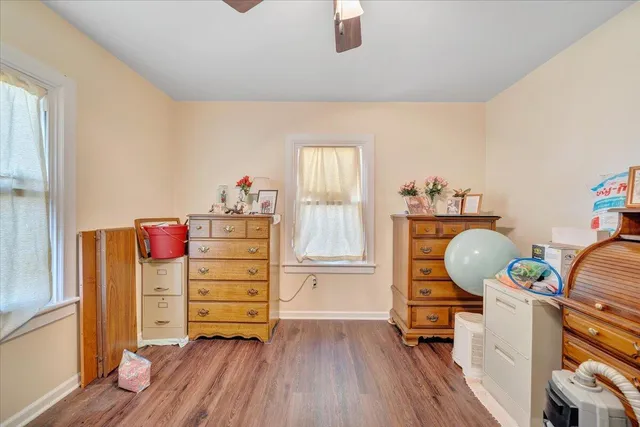 a view of a workspace with furniture and wooden floor