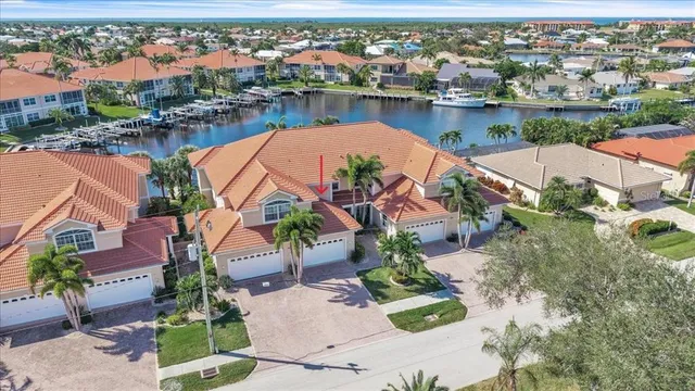 an aerial view of residential houses with outdoor space and lake view