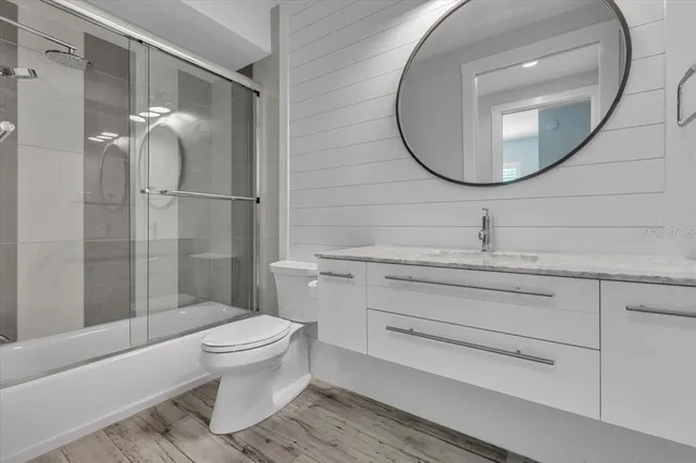 a bedroom with furniture and a flat screen tv