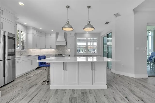 a large kitchen with a stove top oven sink and cabinets