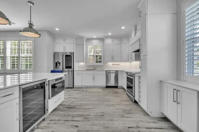 a large kitchen with a table and chairs
