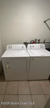 a utility room with a sink washer and dryer