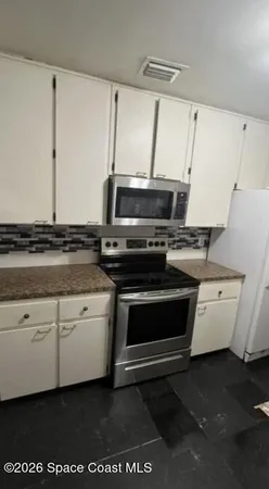 a kitchen with a stove and a microwave