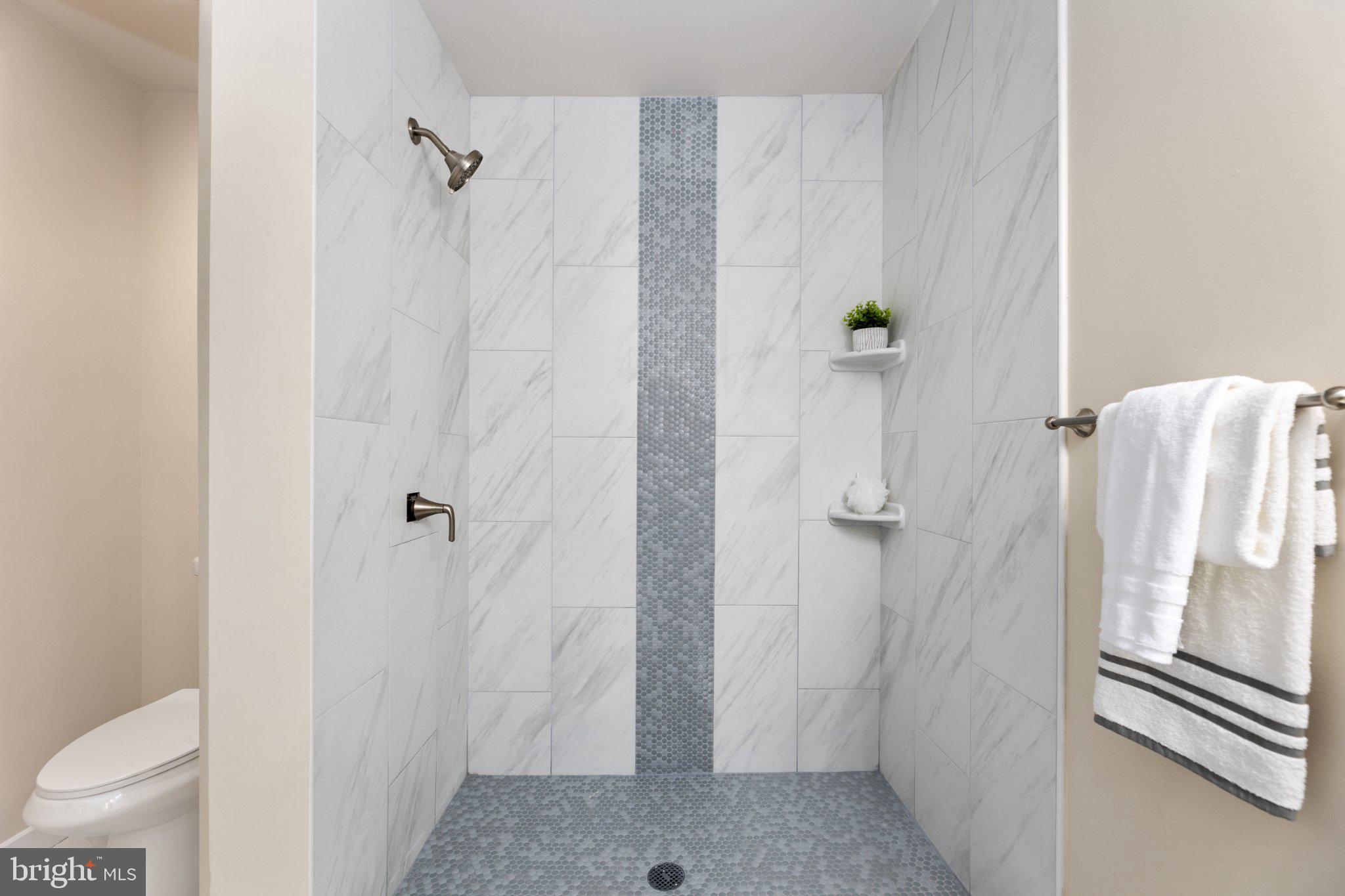 3215 Edgewood Road Kensington, MD 20895 - Photo 31 of 37 Sleek marble shower with modern accents.