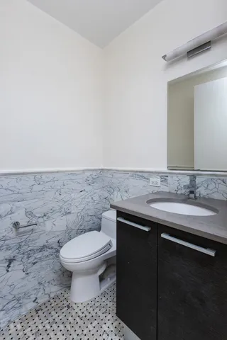 a bedroom with a bed and a chair