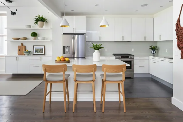a dining room with furniture potted plants and wooden floor
