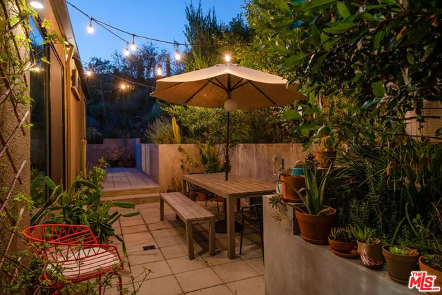 an outdoor space with furniture and umbrella