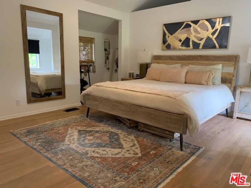 25761 Vista Verde Drive Calabasas, CA 91302 - Photo 14 of 22 a bedroom with a bed and a dresser