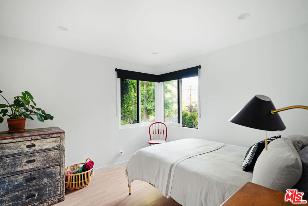 25761 Vista Verde Drive Calabasas, CA 91302 - Photo 15 of 22 a bedroom with a bed and a potted plant