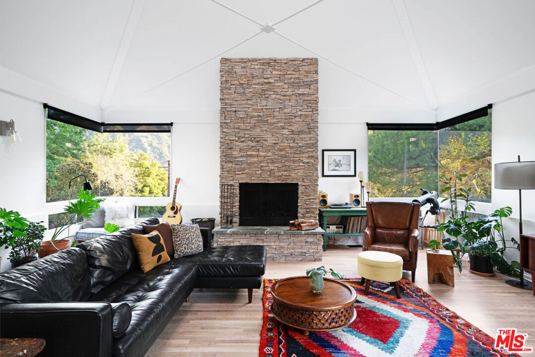 25761 Vista Verde Drive Calabasas, CA 91302 - Photo 4 of 22 a living room with furniture fireplace and a large window