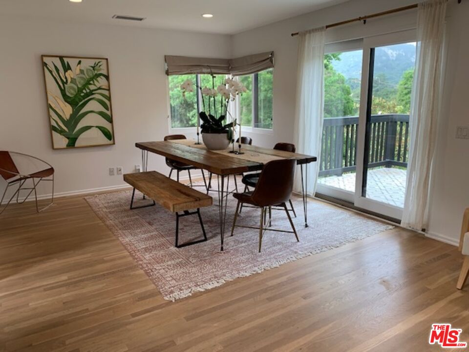 25761 Vista Verde Drive Calabasas, CA 91302 - Photo 9 of 22 a view of a dining room with furniture window and wooden floor