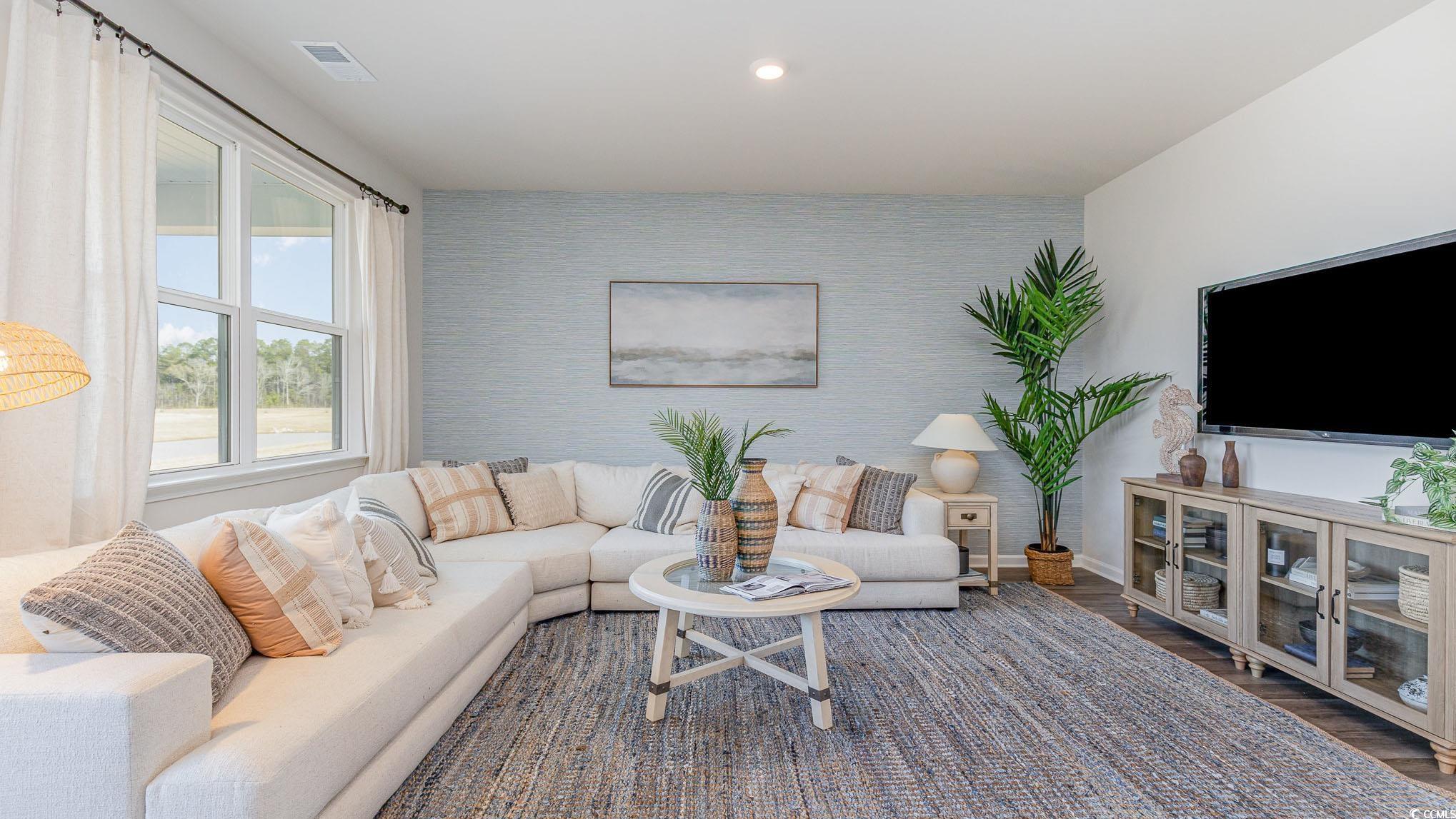 592 Duvall Street Longs, SC 29568 - Photo 11 of 28 Living area with an accent wall, wood finished floors, recessed lighting, and wallpapered walls