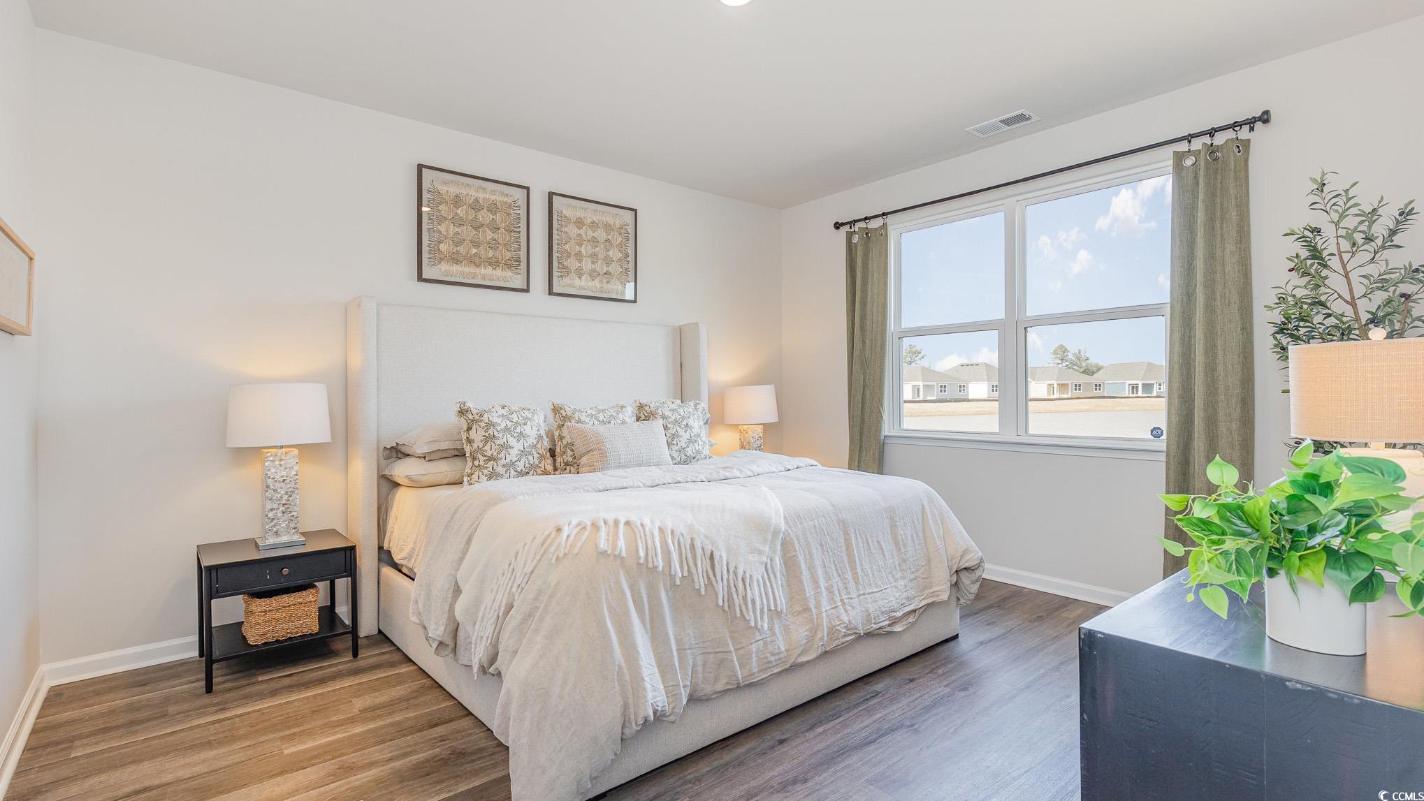 592 Duvall Street Longs, SC 29568 - Photo 13 of 28 Bedroom featuring wood finished floors and baseboards