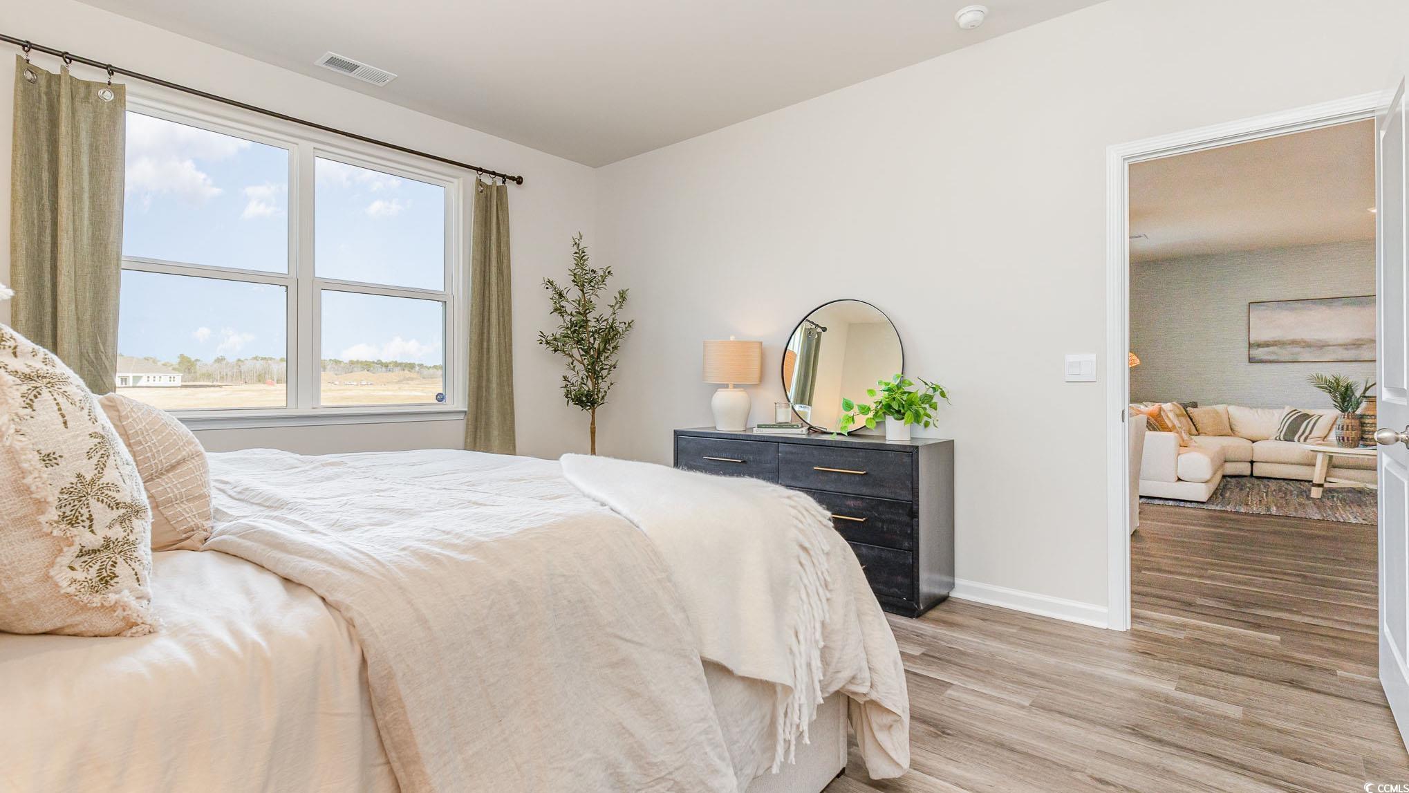 592 Duvall Street Longs, SC 29568 - Photo 14 of 28 Bedroom with light wood-style flooring and baseboards
