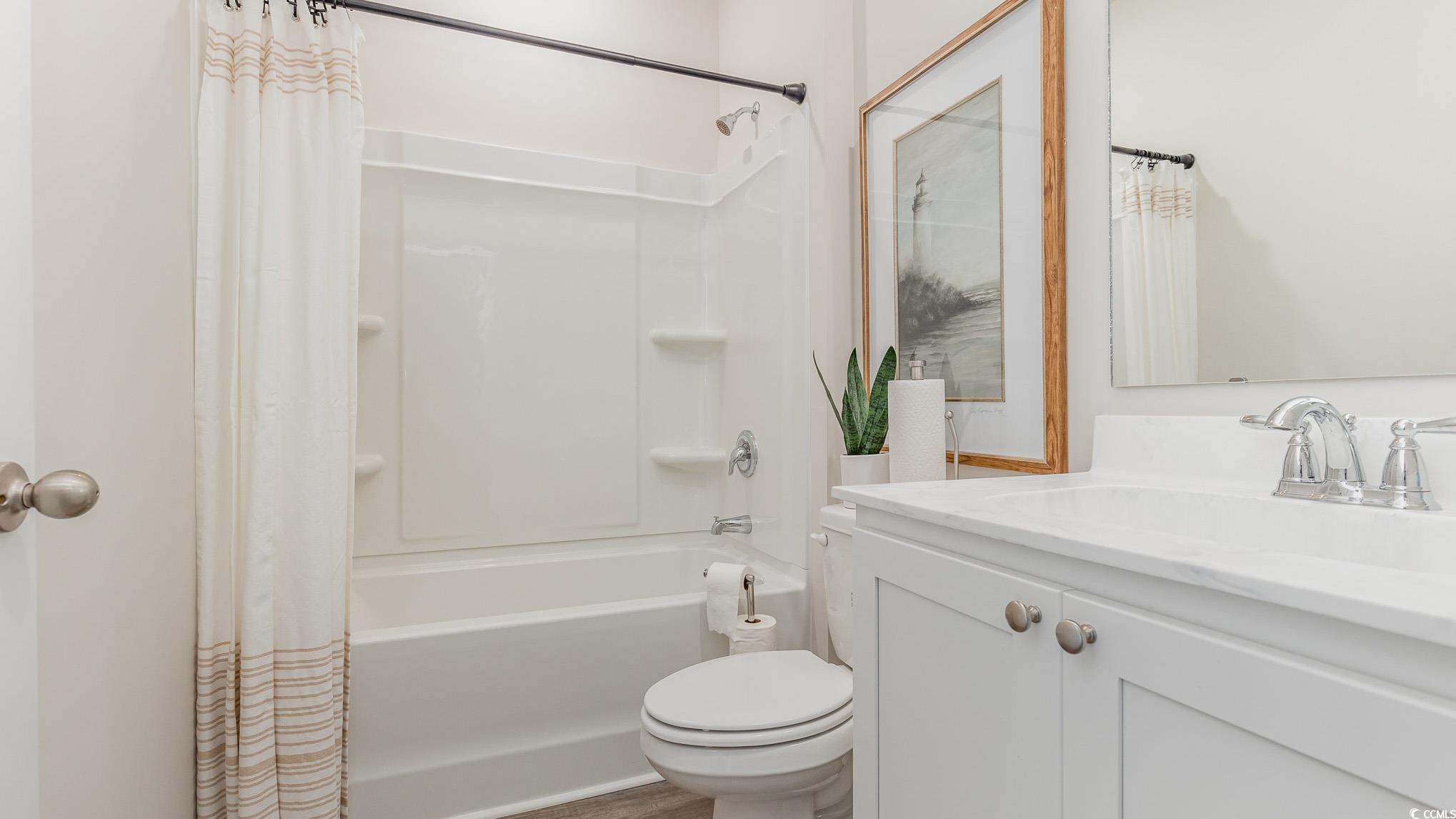 592 Duvall Street Longs, SC 29568 - Photo 21 of 28 Full bathroom with vanity and shower / tub combo with curtain