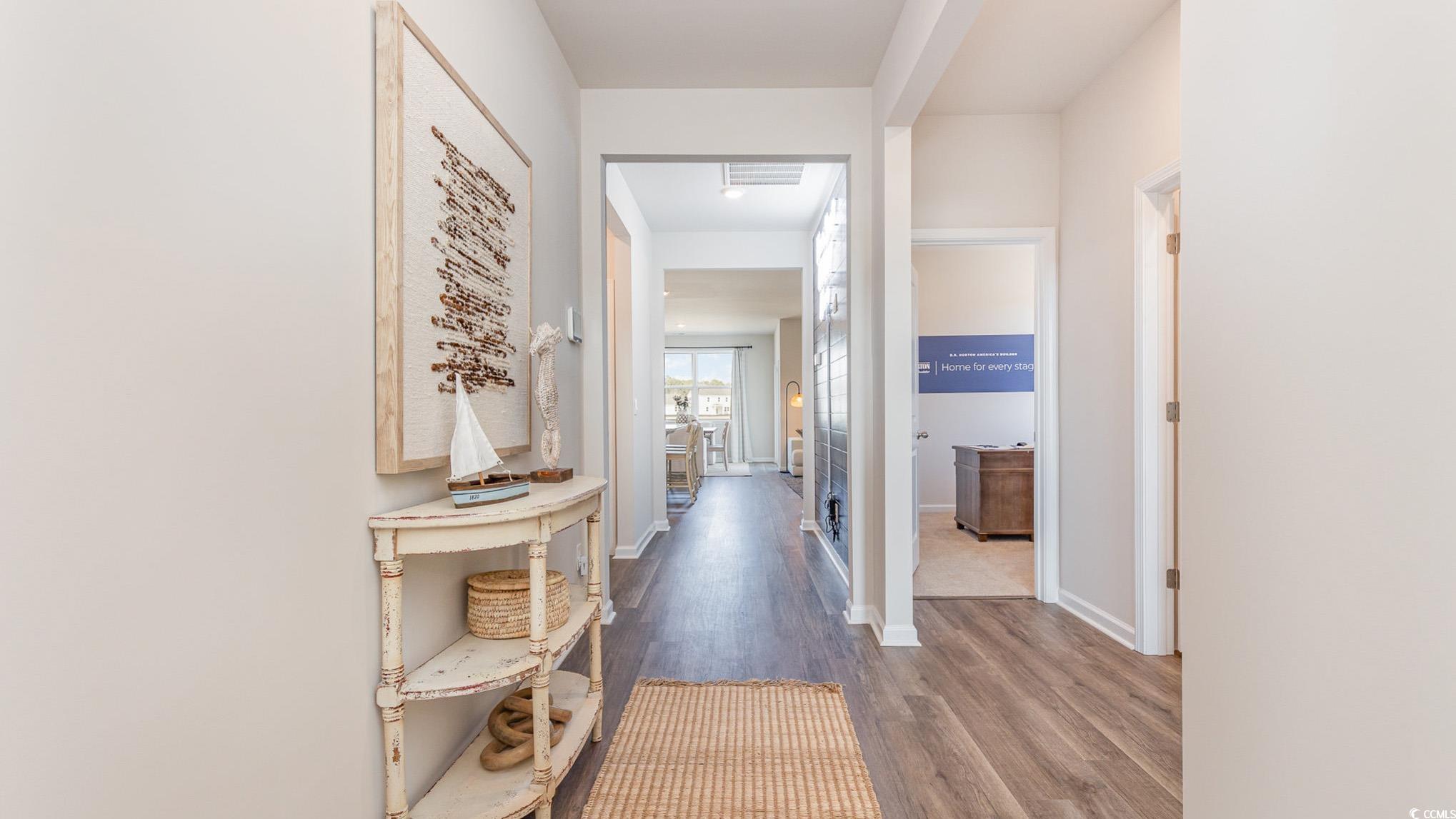 592 Duvall Street Longs, SC 29568 - Photo 4 of 28 Hallway with dark wood finished floors and baseboards
