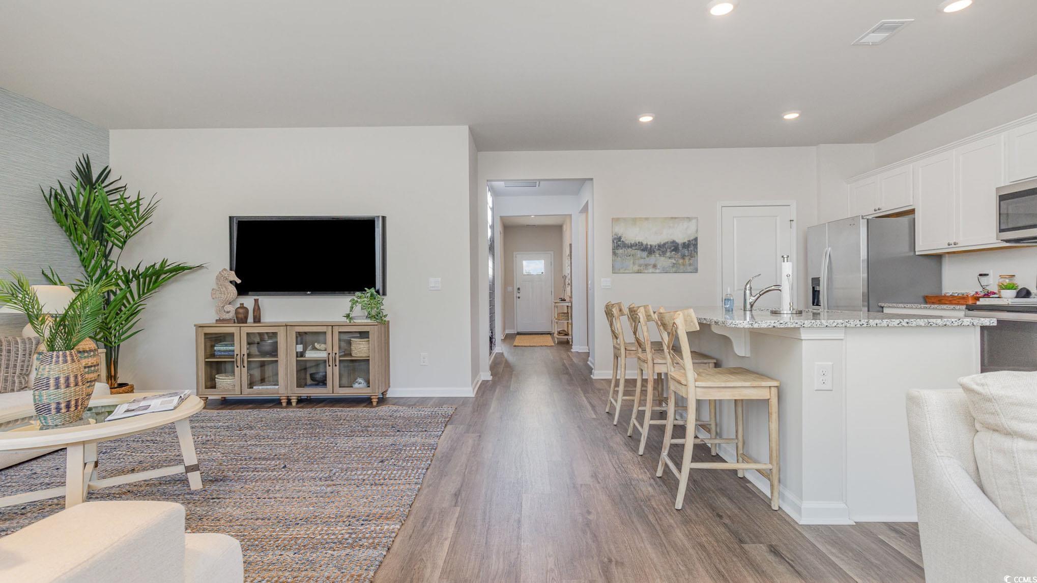 592 Duvall Street Longs, SC 29568 - Photo 8 of 28 Living area featuring dark wood-style floors and recessed lighting