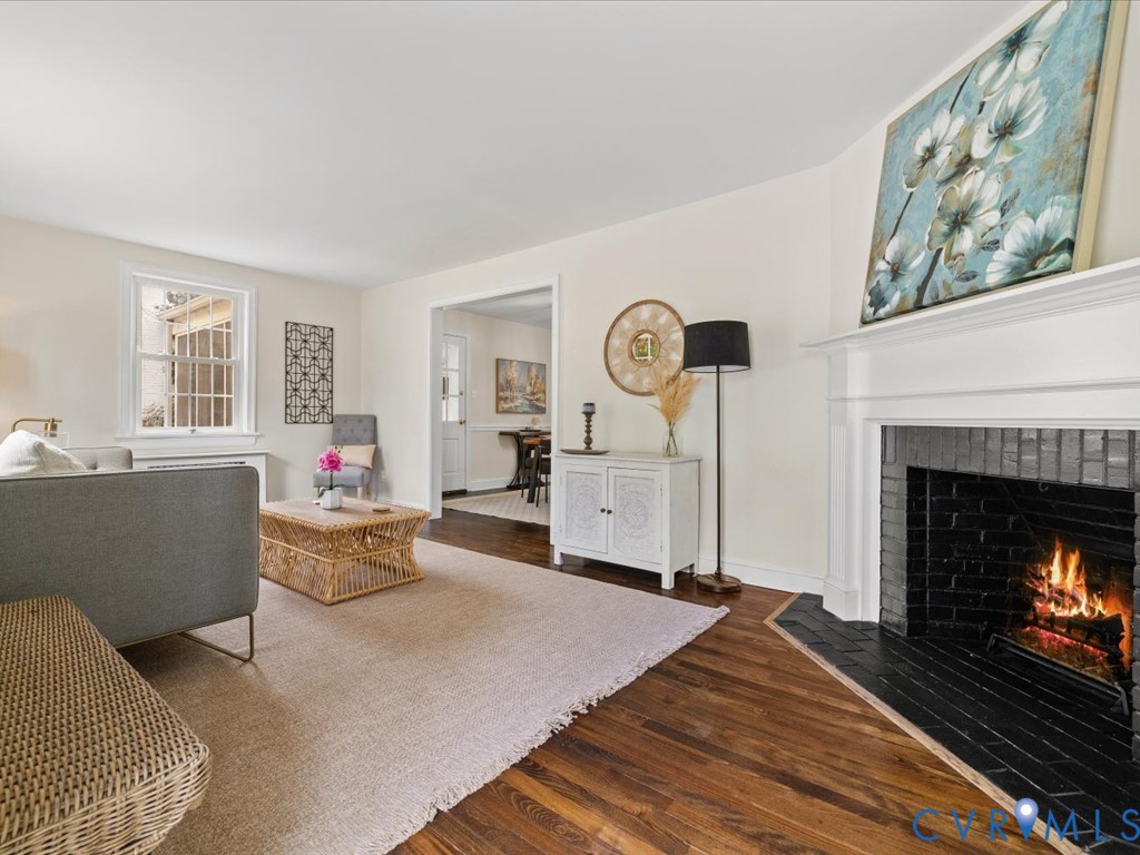 4803 Morrison Road Richmond, VA 23230 - Photo 7 of 45 a living room with furniture a clock and a fireplace