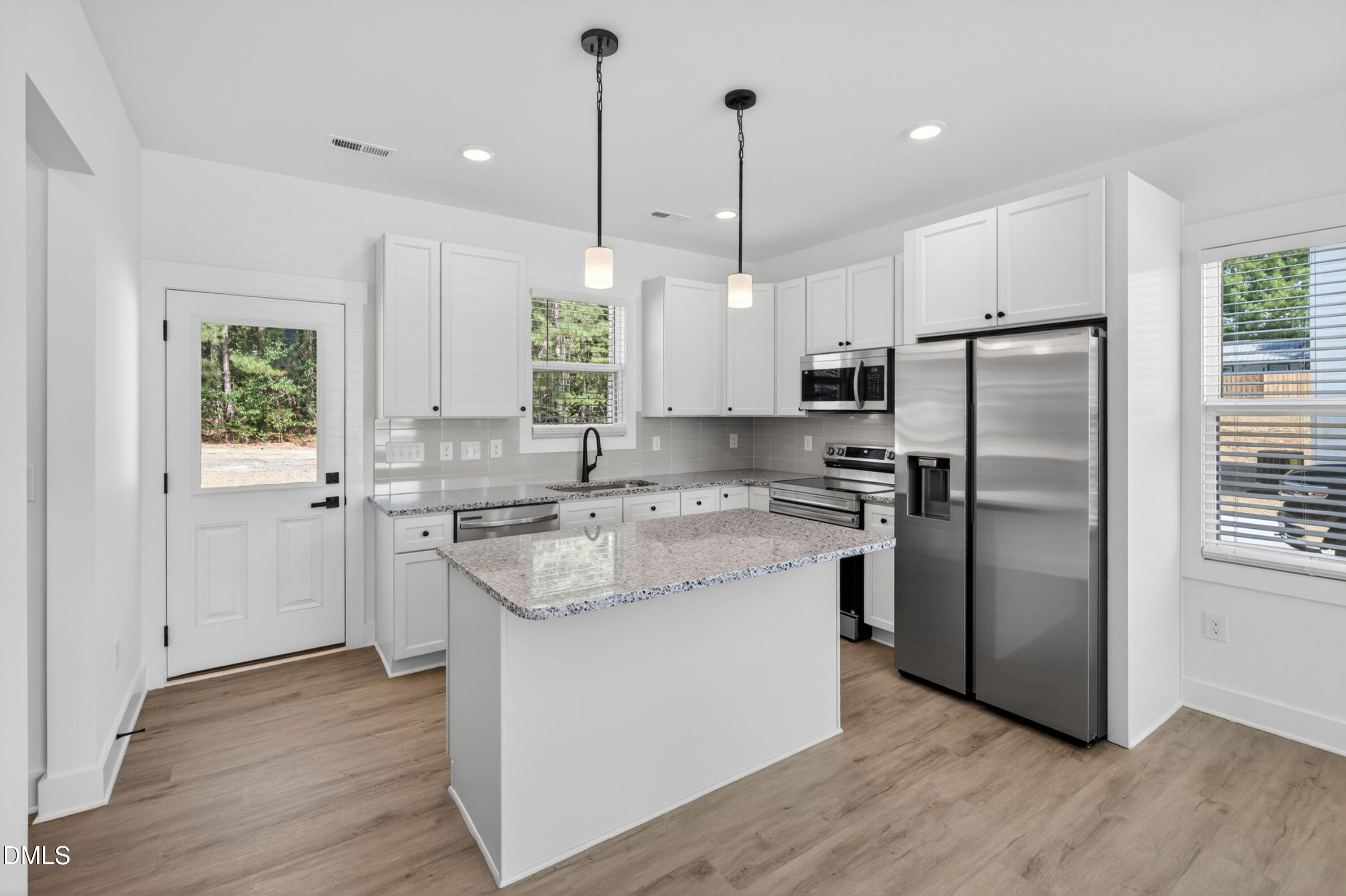 1196 Hurdle Mills Road Roxboro, NC 27573 - Photo 17 of 50 a kitchen with a refrigerator a sink and wooden floor