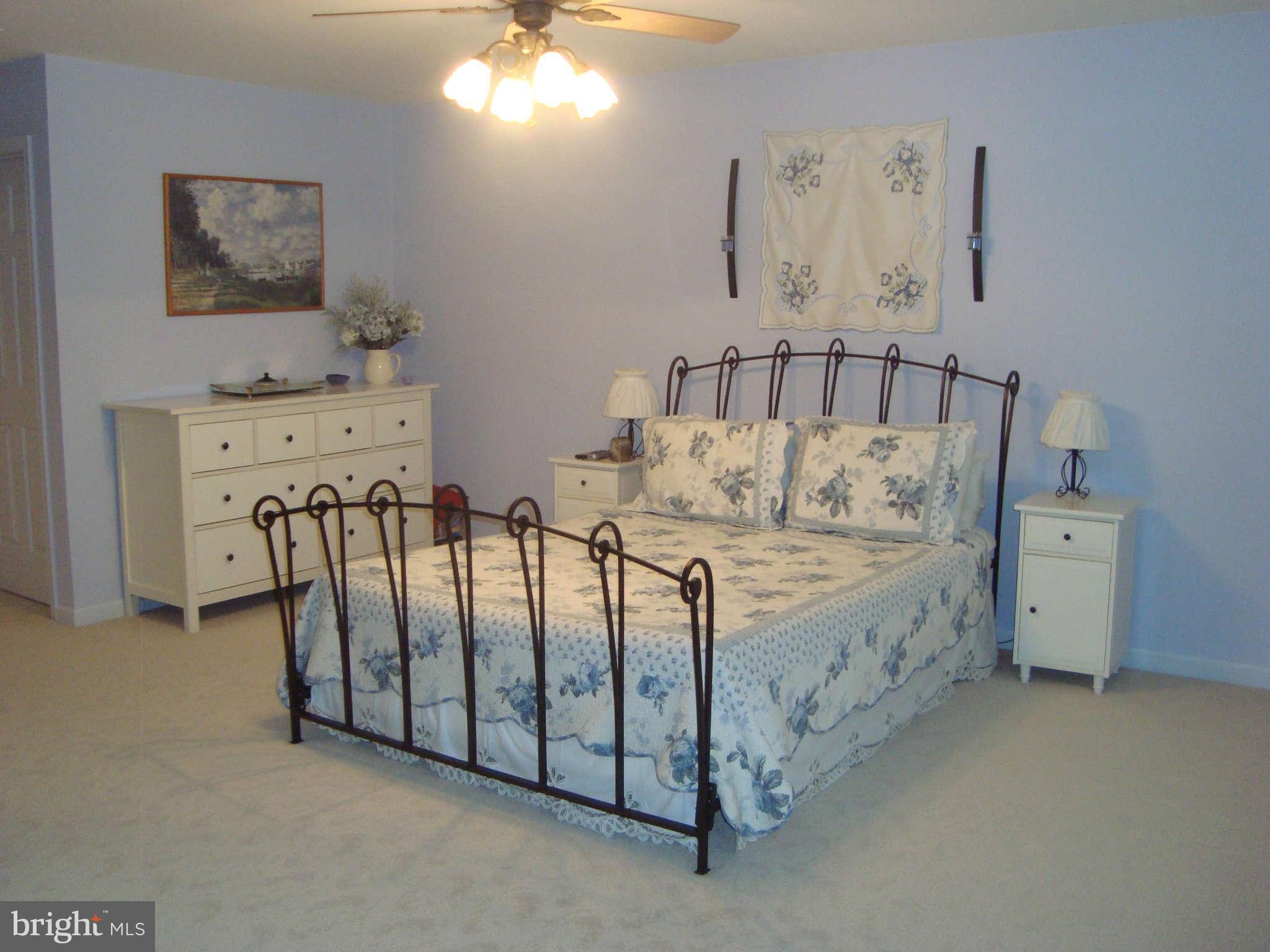 1901 Wilson Road White Hall, MD 21161 - Photo 17 of 26 a bed sitting in a bedroom next to a lamp