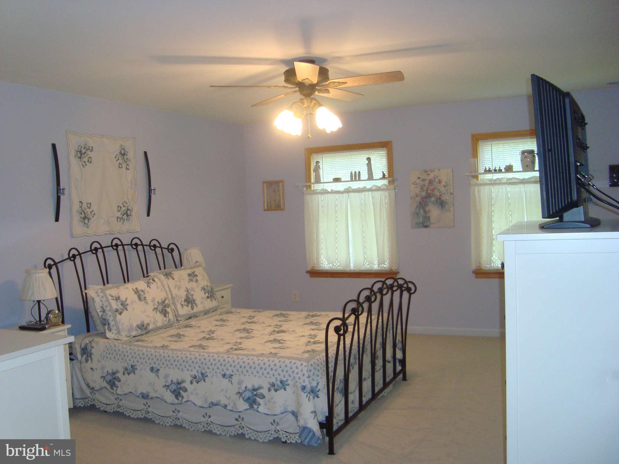 1901 Wilson Road White Hall, MD 21161 - Photo 18 of 26 a bedroom with a bed and a chandelier