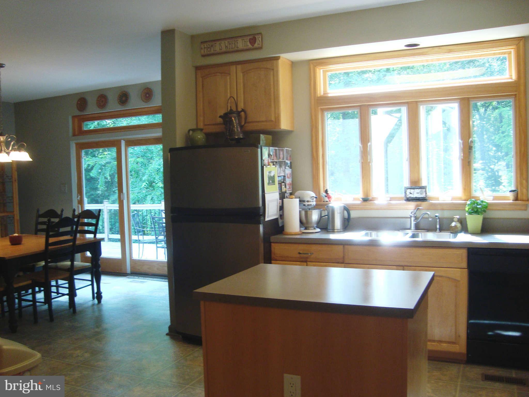 1901 Wilson Road White Hall, MD 21161 - Photo 9 of 26 a kitchen with granite countertop a refrigerator a stove and a dining table