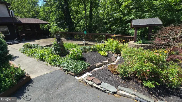 a front view of a house with a yard and shrubs