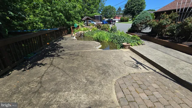 a view of a garden with wooden bench