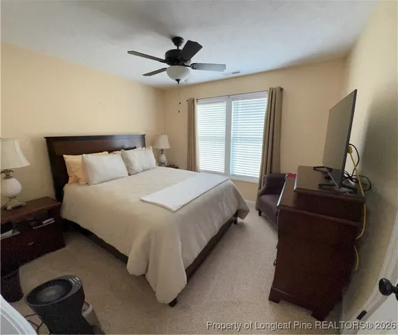 a bedroom with bed and window