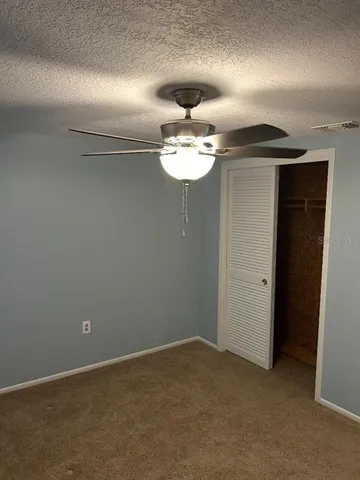 a view of a chandelier fan and fire place
